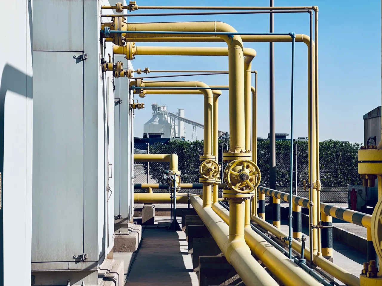 Industrial pipeline infrastructure with valves and pipe supports